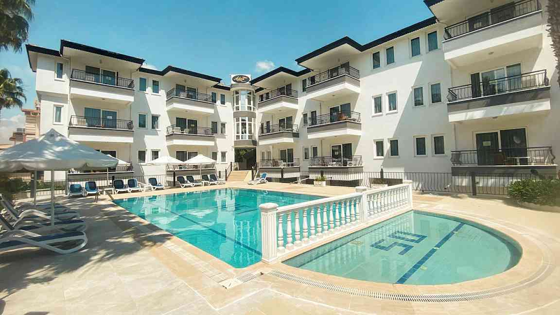 Kerrostalon parvekkeet, jotka avautuvat uima-allasalueelle. (Tekoälyn luoma teksti)