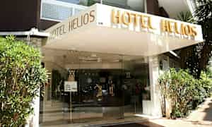 Hotel Helios -hotellin sisäänkäynti, jossa on nimi kirjoitettuna sisäänkäynnin yläpuolelle. (Tekoälyn luoma teksti)