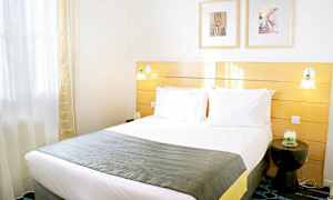 Vaalea hotellihuone, jossa on parivuode ja moderni sisustus. (Tekoälyn luoma teksti)