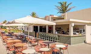 Ulkoterassiravintola, jossa baari ja istumapaikkoja katosten alla. (Tekoälyn luoma teksti)