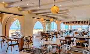 Ravintola, jossa katetut pöydät ja merinäköala. (Tekoälyn luoma teksti)