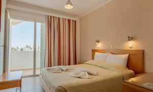 Makuuhuone, jossa on parivuode koristeltuna pyyhkeillä, ja parveke näkymällä. (Tekoälyn luoma teksti)