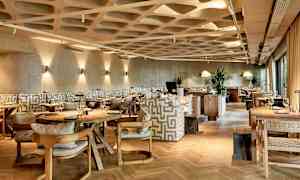 Kuva nykyaikaisesta ravintolasta, jossa on tyylikäs sisustus. (Tekoälyn luoma teksti)