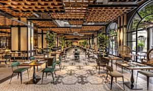 Houkutteleva ravintola, jossa on tyylikäs sisustus, pöydät ja tuolit sekä vihreitä kasveja koristeena. (Tekoälyn luoma teksti)