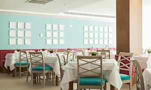 Ravintola, jossa on katetut pöydät ja värikäs sisustus. (Tekoälyn luoma teksti)