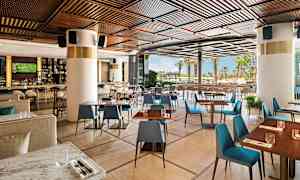 Moderni ravintola puuyksityiskohdilla ja näkymä ulkotiloihin. (Tekoälyn luoma teksti)