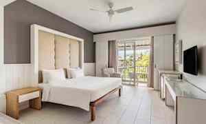 Hotellihuone, jossa on parivuode, moderni sisustus ja parveke näköalalla. (Tekoälyn luoma teksti)