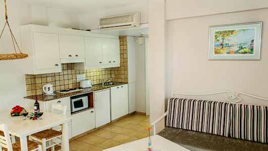 Kuva valoisan sisustuksen keittiöstä ja olohuoneesta, joissa on modernit huonekalut. (Tekoälyn luoma teksti)