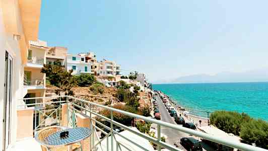 Näköala parvekkeelta merelle, autot pysäköitynä tien varrella ja lähellä olevat rakennukset. (Tekoälyn luoma teksti)