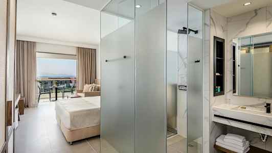 Moderni hotellihuone, josta näkymä parvekkeelle. (Tekoälyn luoma teksti)