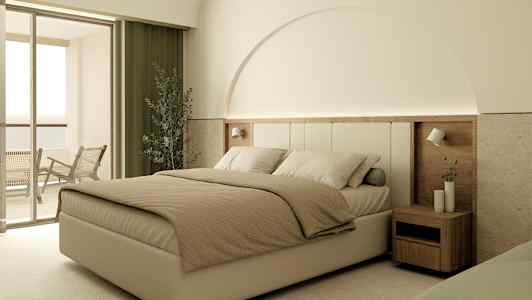 Hotellihuone, jossa suuri sänky, yöpöytä ja parveke. (Tekoälyn luoma teksti)