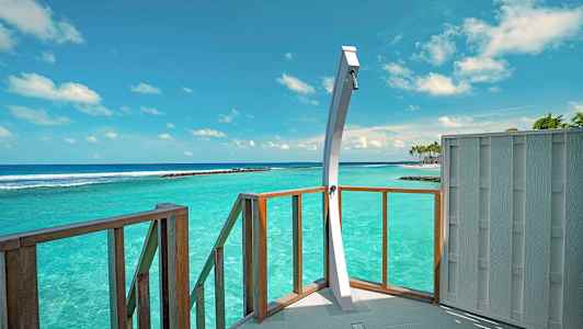 Suihku terassilla, näkymä turkoosiin mereen kirkkaan taivaan alla. (Tekoälyn luoma teksti)