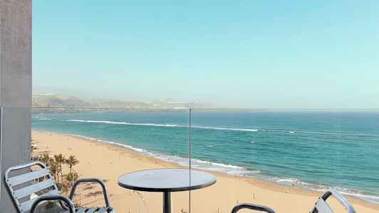 Näkymä parvekkeelta hiekkarannalle ja merelle. (Tekoälyn luoma teksti)