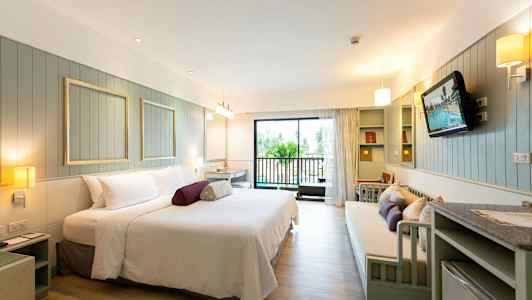 Tilava hotellihuone, jossa on modernit kalusteet ja parveke. (Tekoälyn luoma teksti)