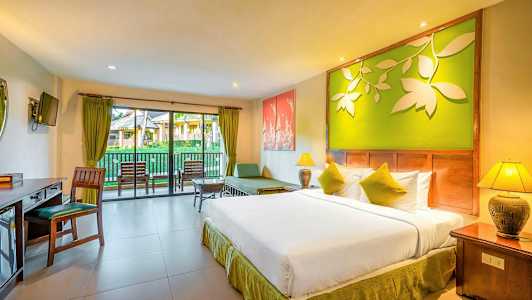 Hotellihuone, jossa on parivuode, istuinryhmä ja parveke näkymällä puutarhaan. (Tekoälyn luoma teksti)