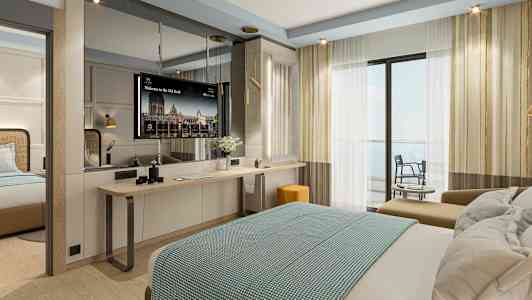 Hotellihuone, jossa on parivuode, työpöytä ja parvekkeenäkymä. (Tekoälyn luoma teksti)