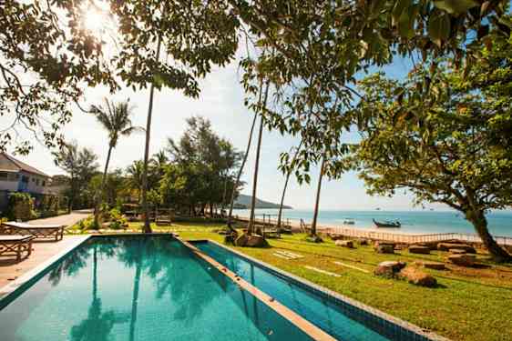 Kuva uima-altaasta, jossa on vihreä ulkoalue ja näkymä merelle taustalla. (Tekoälyn luoma teksti)