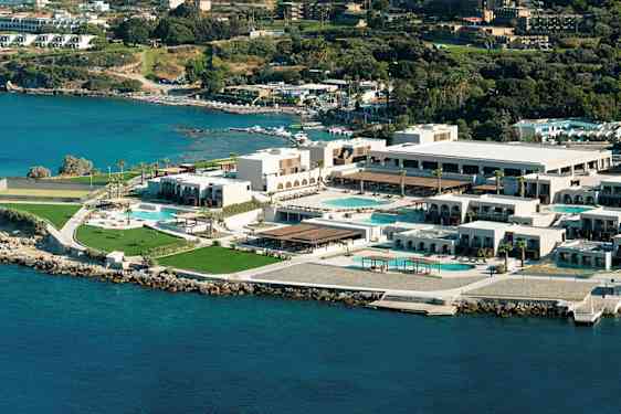 Ilmakuva rannikkohotellikompleksista, jossa on uima-altaita ja viheralueita. (Tekoälyn luoma teksti)