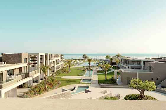 Hotellin moderneja rakennuksia, joissa on allasalueet ja puutarhat lähellä merta. (Tekoälyn luoma teksti)