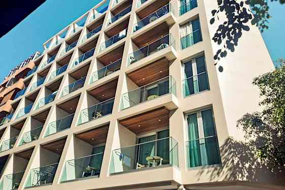 Rakennus, jossa on parvekkeita ja lasikaiteet. (Tekoälyn luoma teksti)