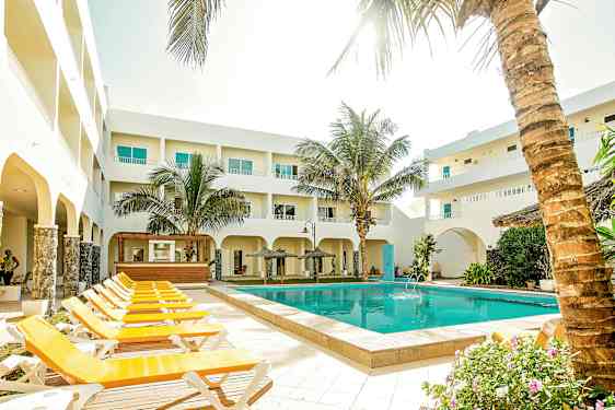 Ulkoalue, jossa uima-allas, aurinkotuoleja ja ympäröiviä rakennuksia. (Tekoälyn luoma teksti)