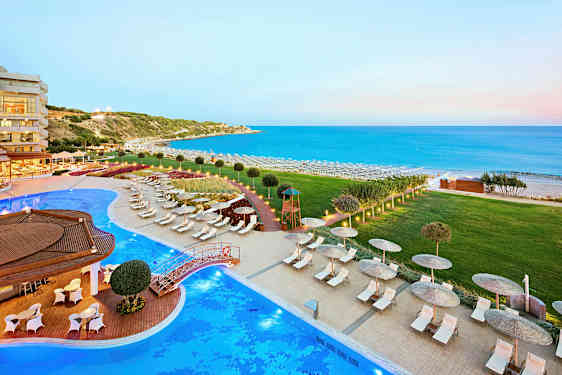 Näkymä ulkoaltaaseen, aurinkotuoleihin ja mereen, jonka taustalla on ranta. (Tekoälyn luoma teksti)