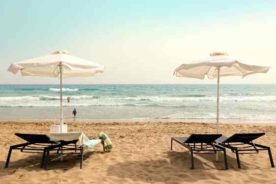 Aurinkotuoleja hiekkarannalla