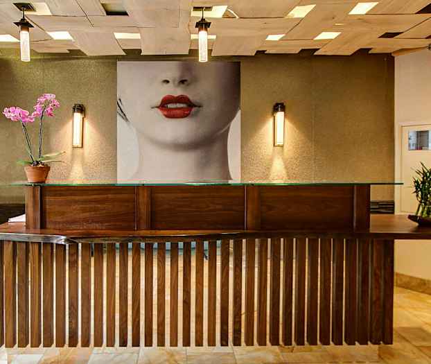 Vastaanotto, jossa on puinen tiski ja koristekasveja tiskillä. (Tekoälyn luoma teksti)