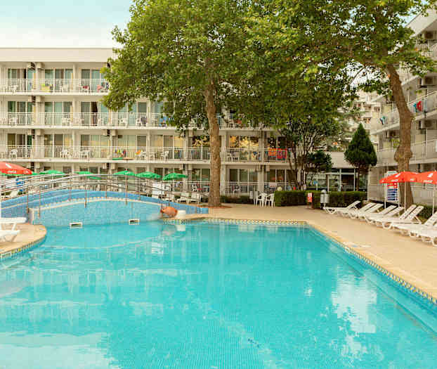 Ulkoallas, jossa on aurinkotuoleja ja varjoja, rakennuksen parvekkeiden edessä. (Tekoälyn luoma teksti)