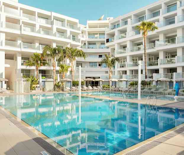 Moderni rakennus parvekkeineen ympäröi ulkouima-allasta. (Tekoälyn luoma teksti)