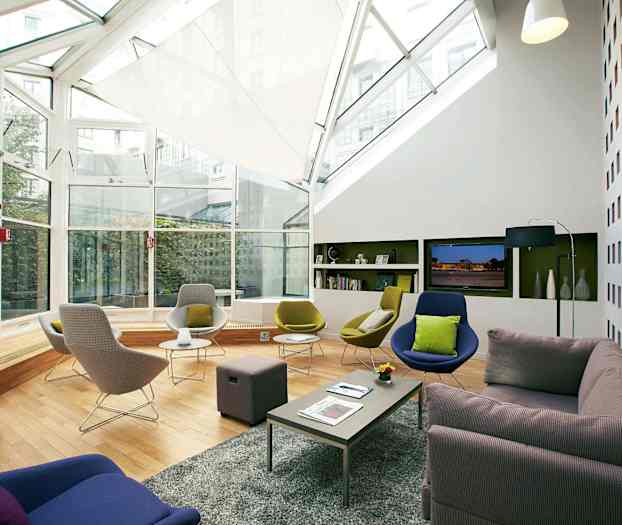 Modernisti sisustettu lounge-tila, jossa on suuret ikkunat ja mukavat istumapaikat. (Tekoälyn luoma teksti)