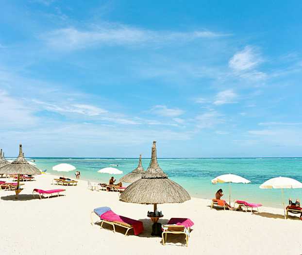 Ranta, jossa on aurinkovarjoja ja aurinkotuoleja meren rannalla. (Tekoälyn luoma teksti)