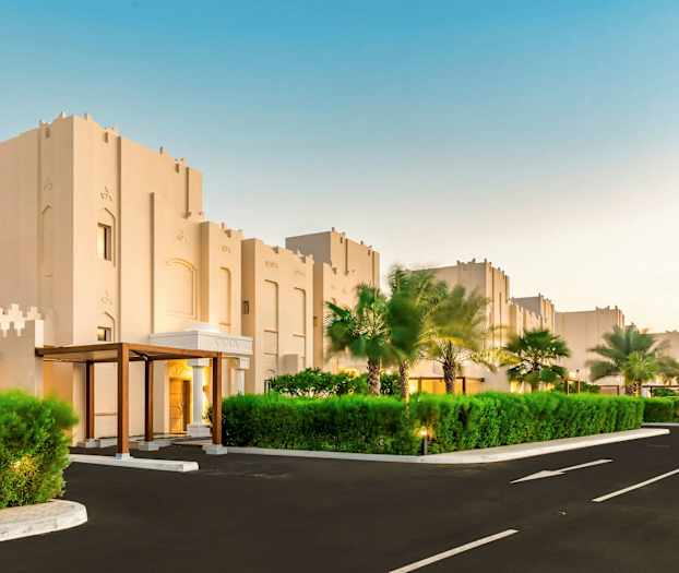 Rakennuksia modernilla arkkitehtuurilla ja ympärillä vehreyttä. (Tekoälyn luoma teksti)