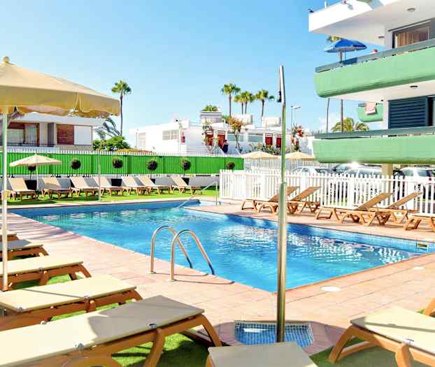 Ulkouima-allas, jossa aurinkotuoleja ja aurinkovarjoja lähellä huoneistokompleksia. (Tekoälyn luoma teksti)