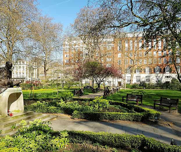 Patsas puistossa, jossa on vihreää ja penkkejä. (Tekoälyn luoma teksti)