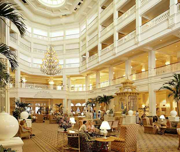 Tilava ja tyylikäs hotellin aula, jossa on korkea katto, upea kattokruunu, mukavat istumapaikat ja koristekasveja. (Tekoälyn luoma teksti)