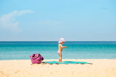 Kata Beachin pehmeällä vaalealla hiekalla  leikkivä pikkulapsu