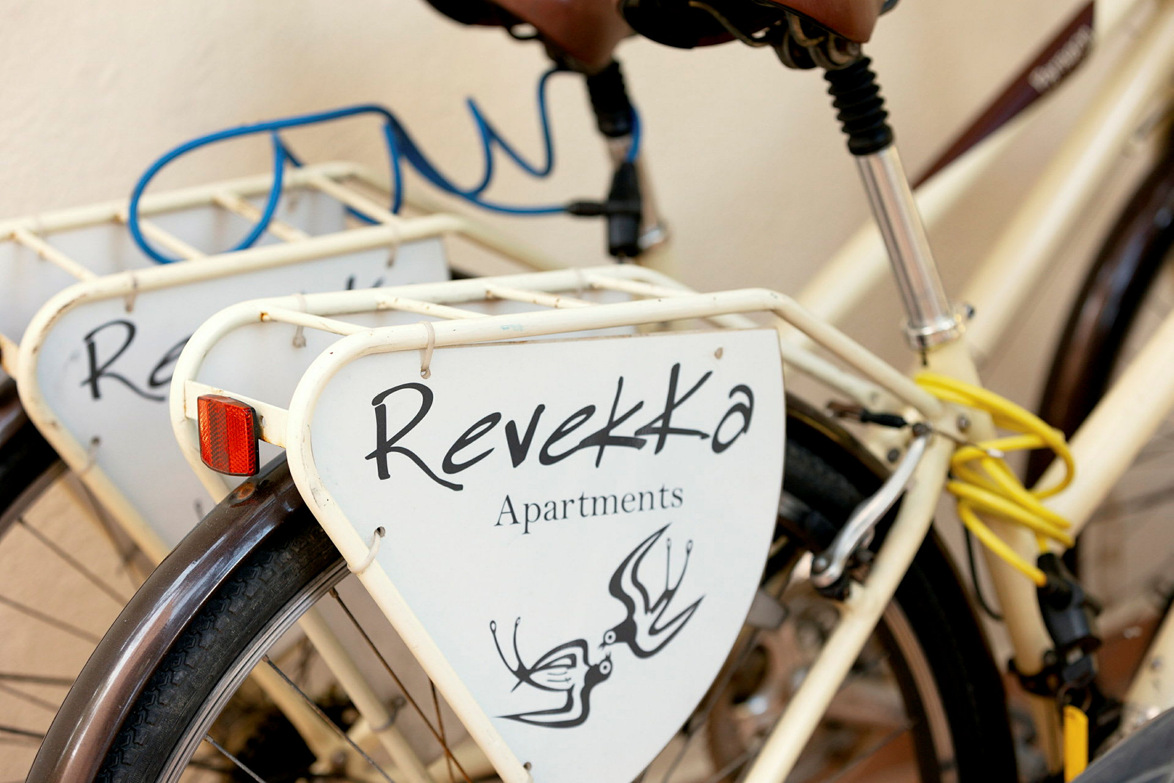 Polkupyörä, jossa kyltti, jossa lukee 'Revekka Apartments'. (Tekoälyn luoma teksti)