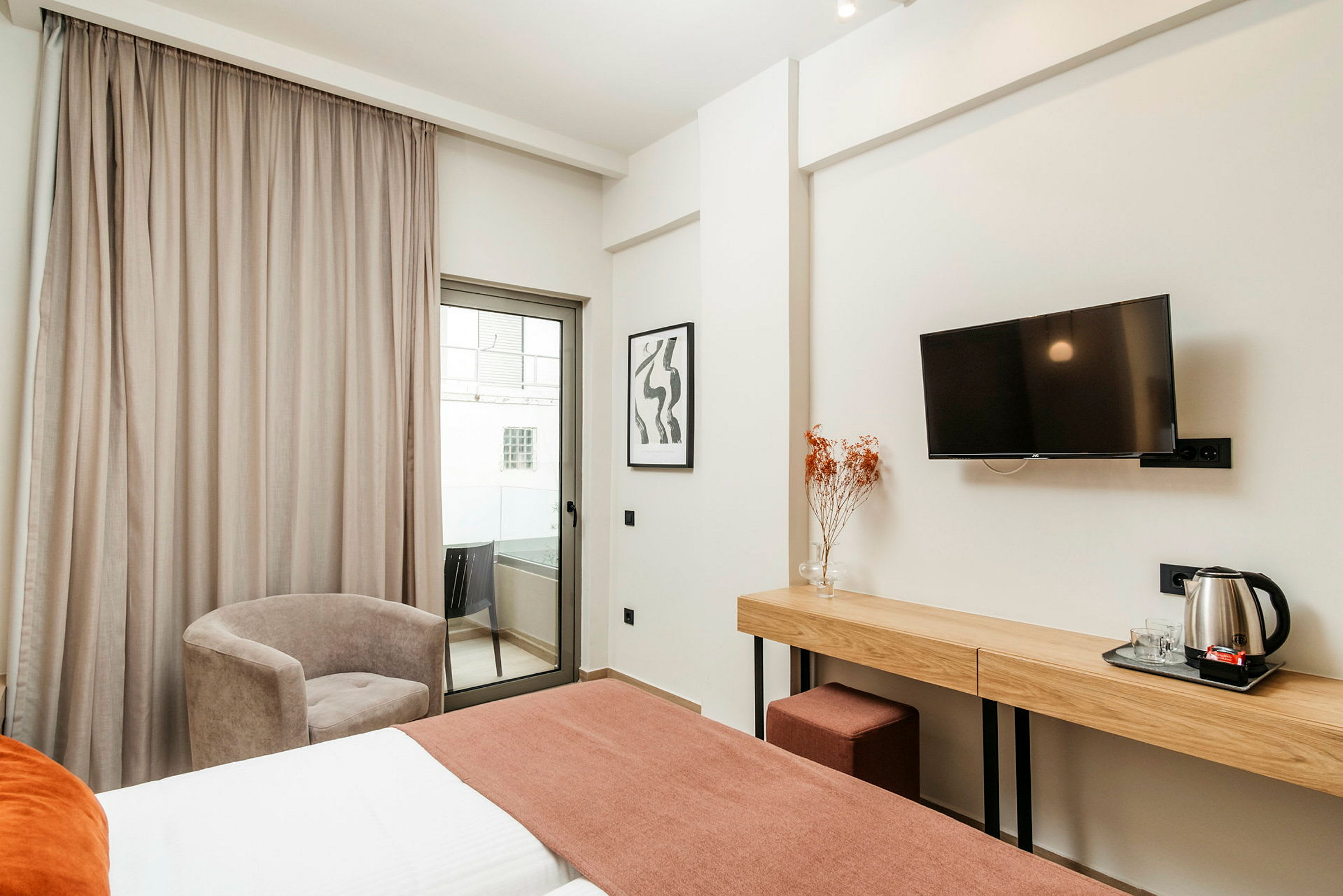 Hotellihuone, jossa sänky, työpöytä, tuoli ja parveke. (Tekoälyn luoma teksti)