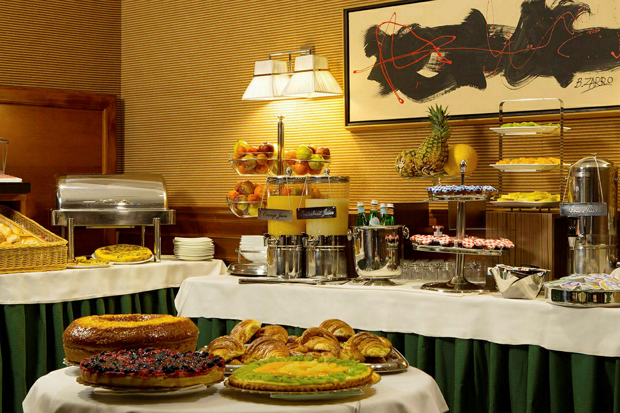 Buffet-pöytä, jossa on erilaisia leivonnaisia, hedelmiä ja juomia. (Tekoälyn luoma teksti)