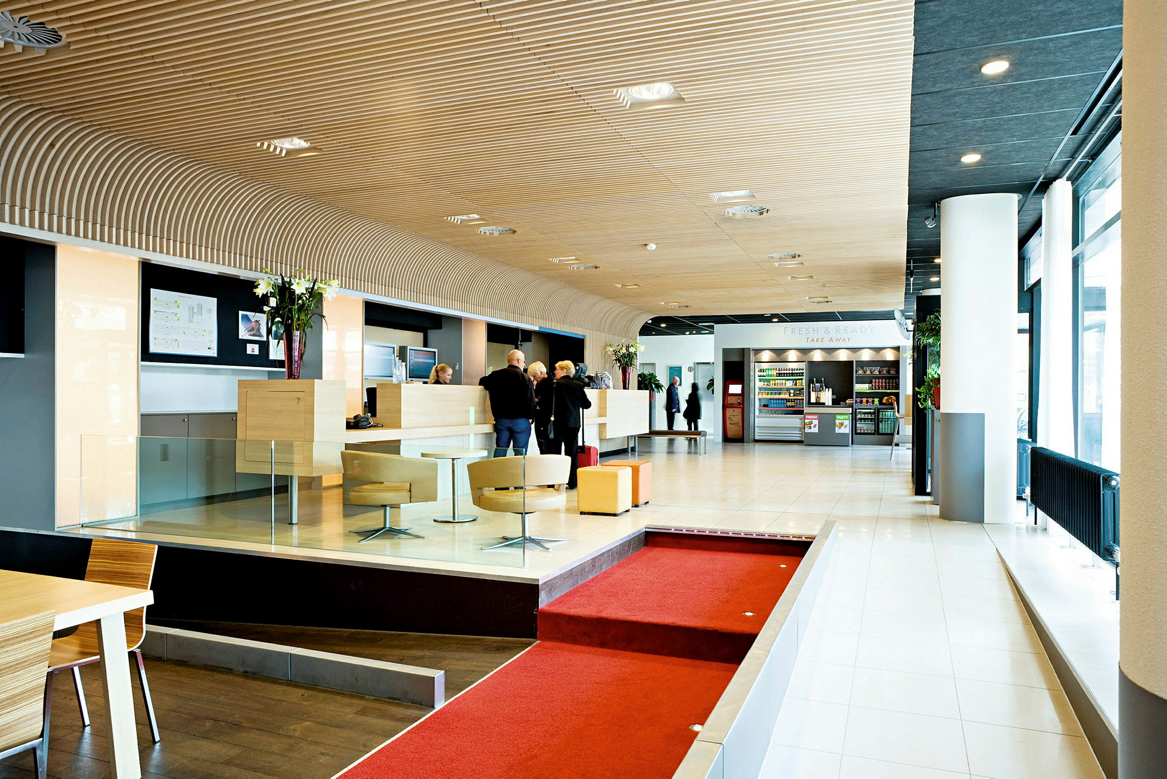 Valoisa ja moderni hotellin aula, jossa on vastaanotto, oleskelualueita ja kioskijuomia ja välipaloja. (Tekoälyn luoma teksti)