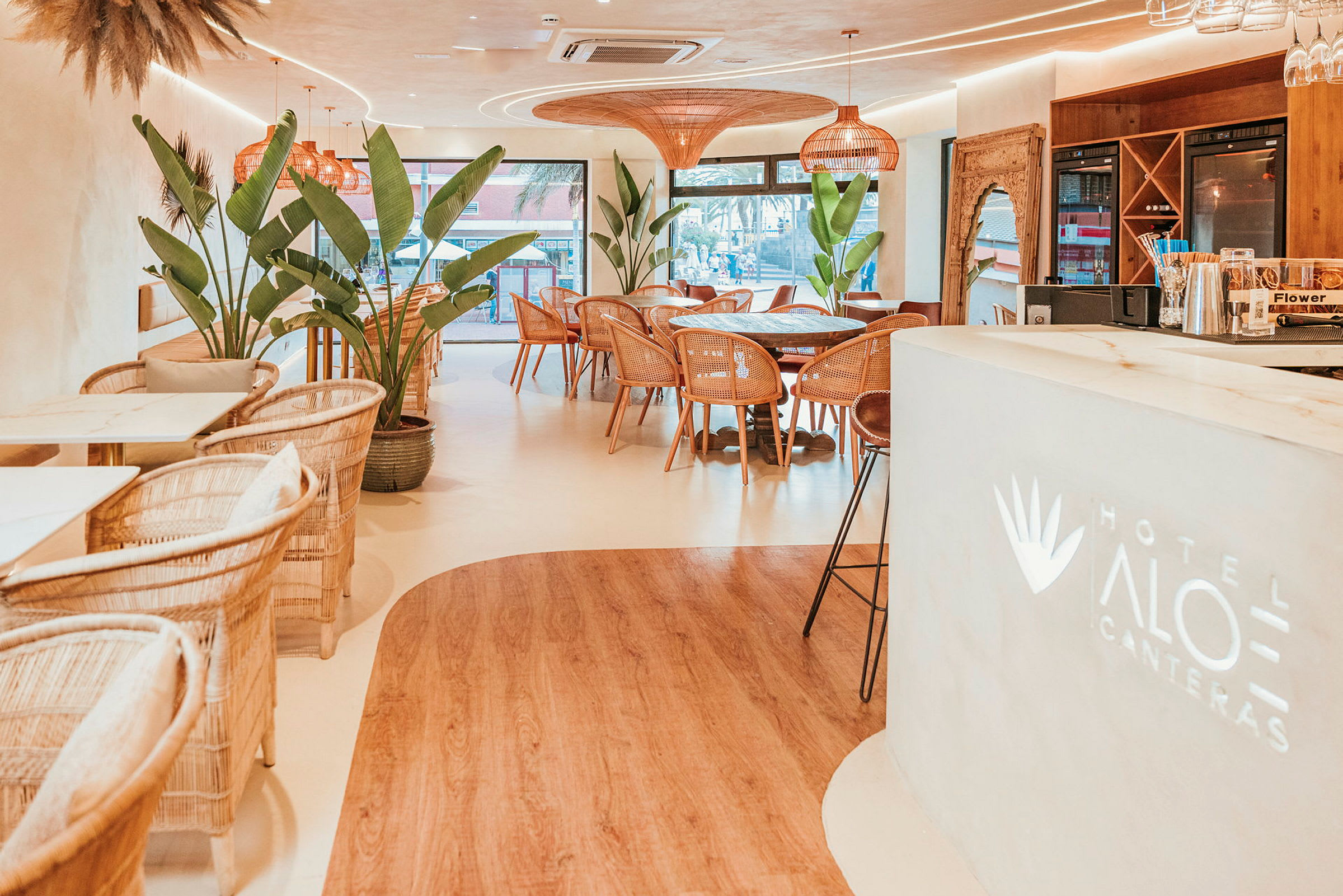 Hotelliravintola, jossa on moderni sisustus ja suuria kasveja. (Tekoälyn luoma teksti)