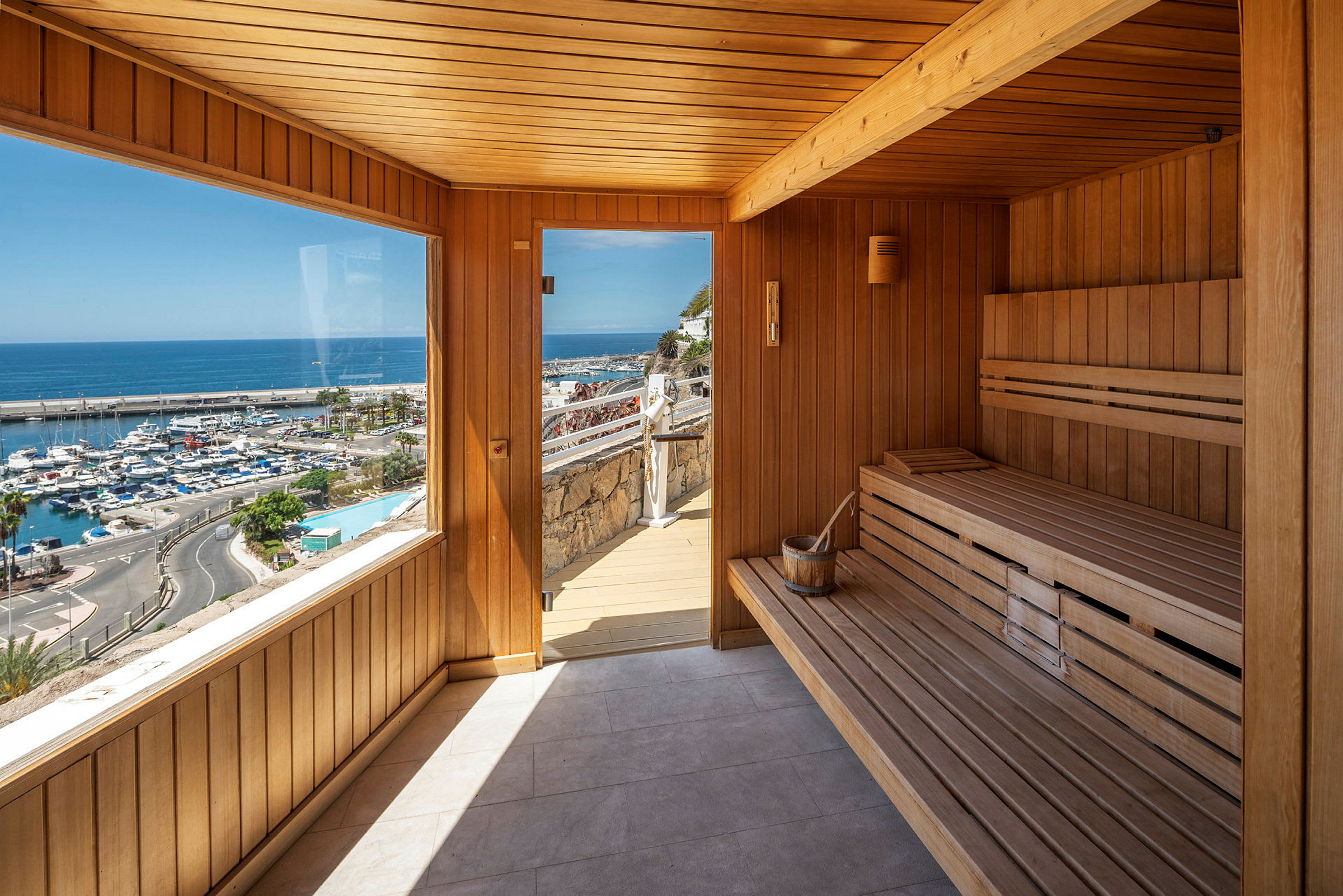 Sauna, jossa on panoraamaikkunat ja näkymät satamaan sekä rantaviivalle. (Tekoälyn luoma teksti)