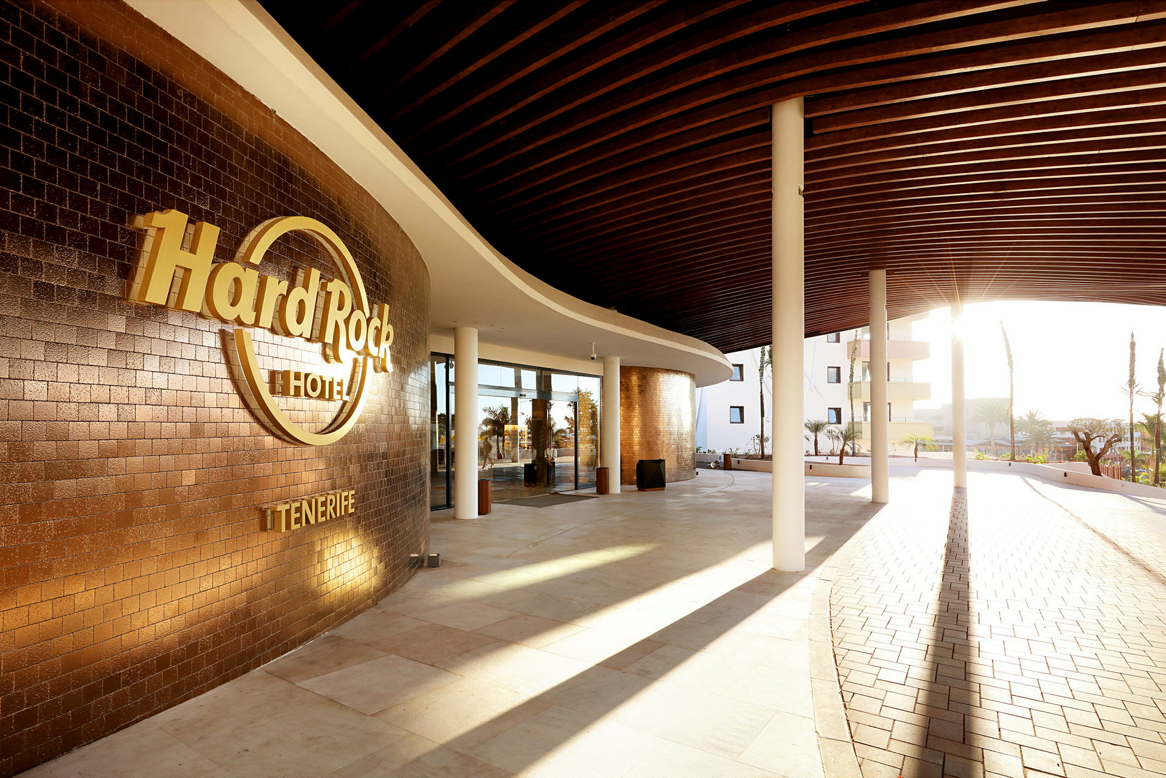 Hard Rock Hotel Tenerifen sisäänkäynti auringonpaisteessa ja modernissa tyyliin. (Tekoälyn luoma teksti)