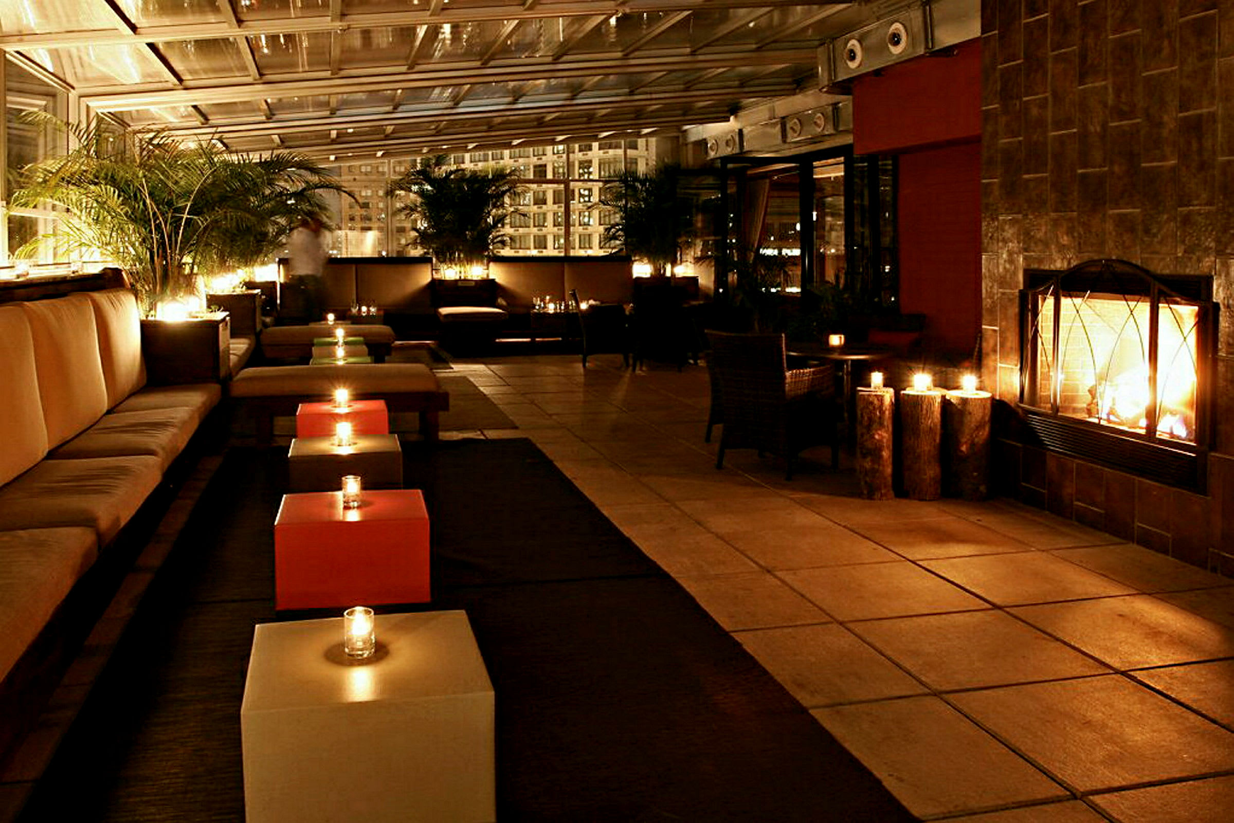 Moderni valaistu lounge-alue, jossa on sohvia, matalia pöytiä ja palava takka. (Tekoälyn luoma teksti)