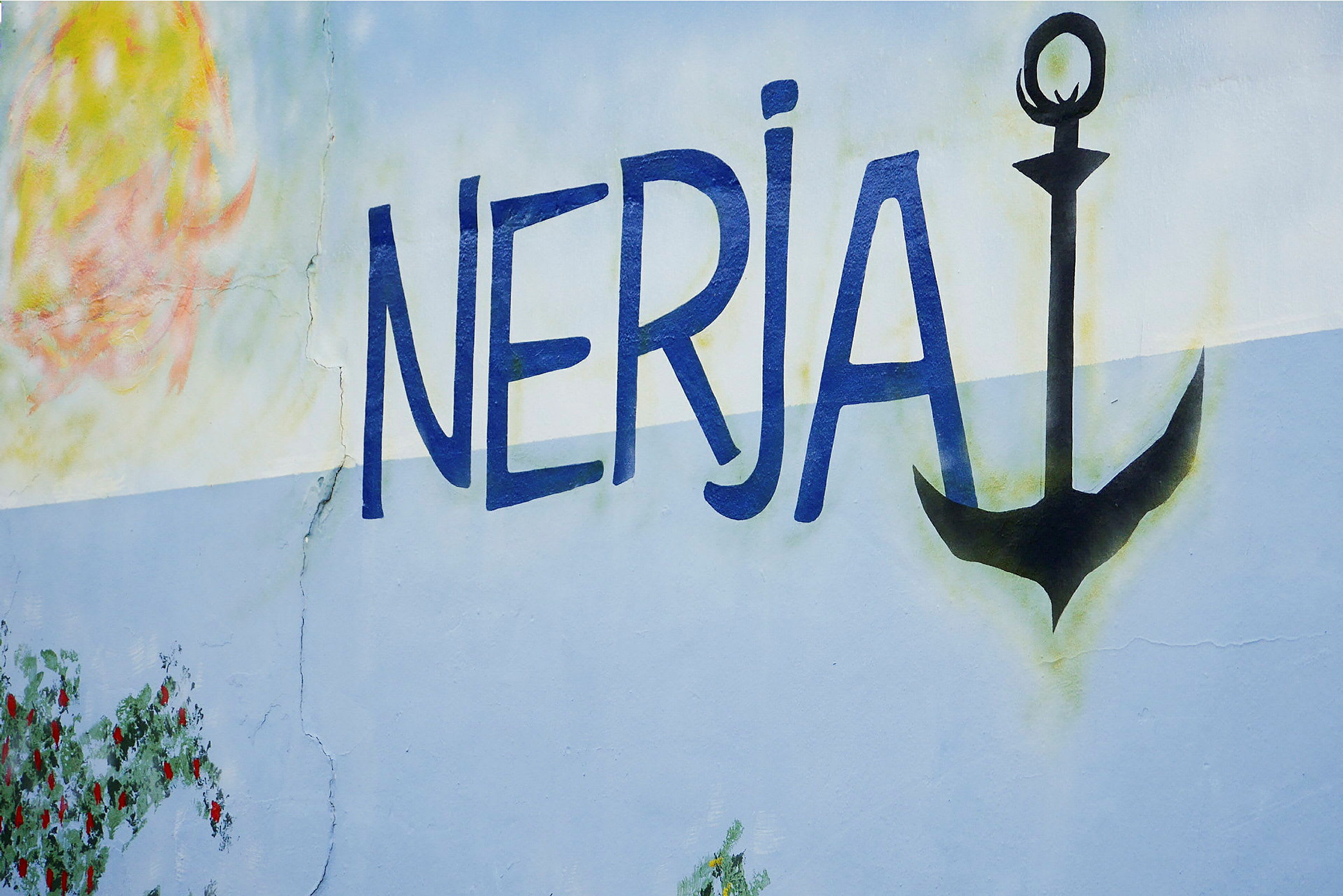 Seinämaalaus, jossa teksti 'Nerja' ja musta ankkuri. (Tekoälyn luoma teksti)